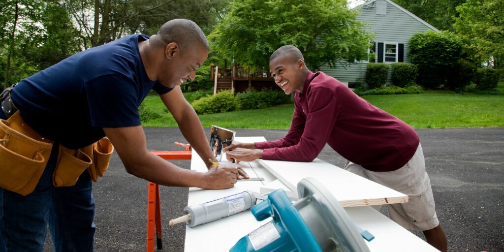 Father and son working on house