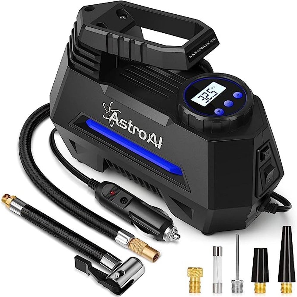 Black portable air compressor with cord and accessories. Handle and digital tire pressure gauge on the top
